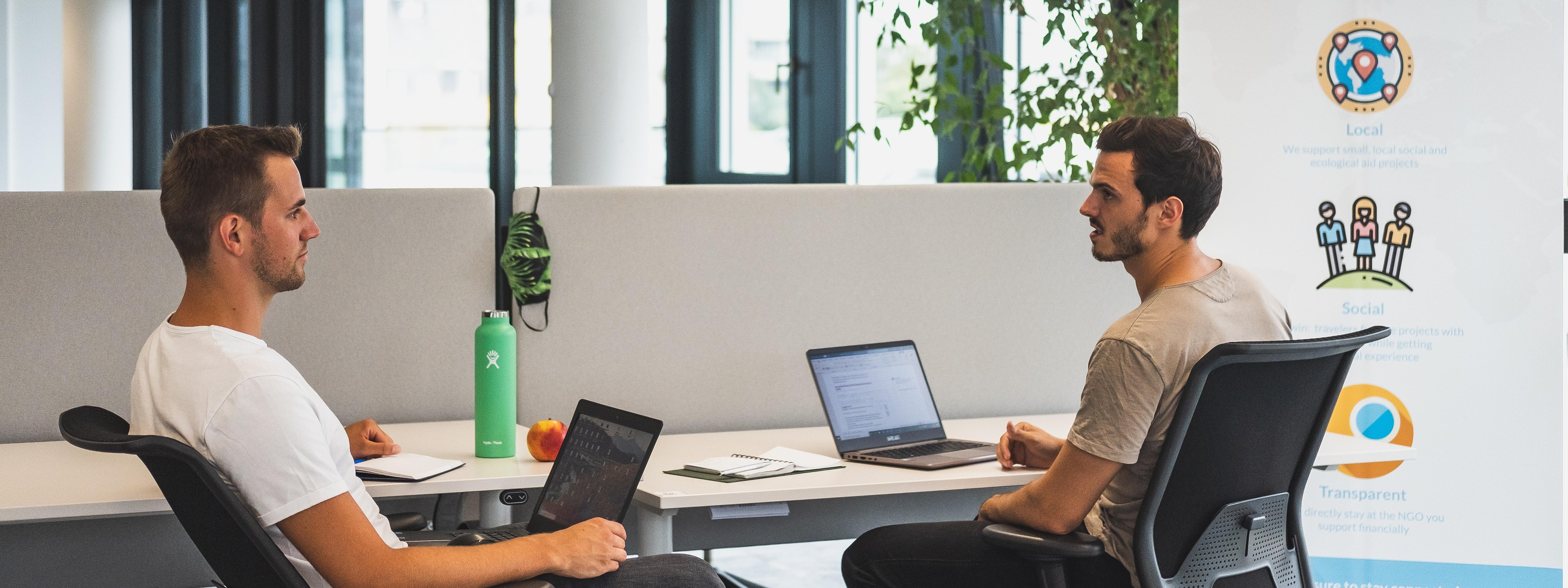 Socialbnb founders sitting at desks with their laptops