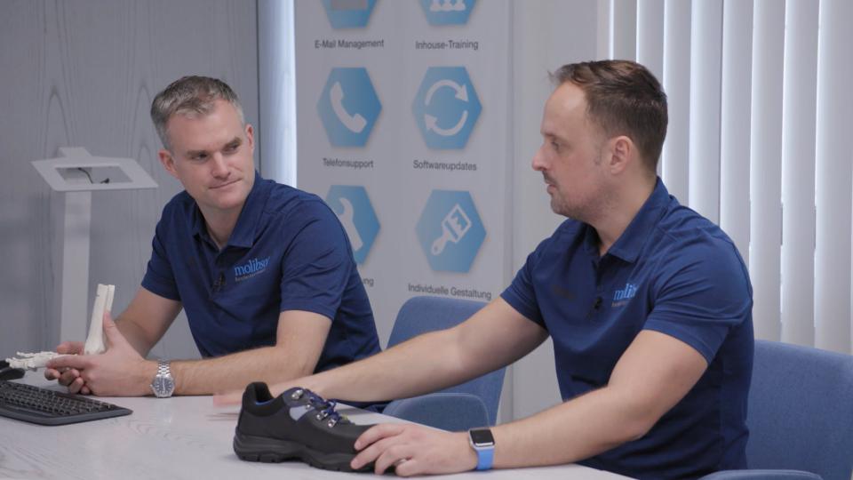 Dr. Jens Hollenbacher and Lars Hollenbacher sitting on a table together