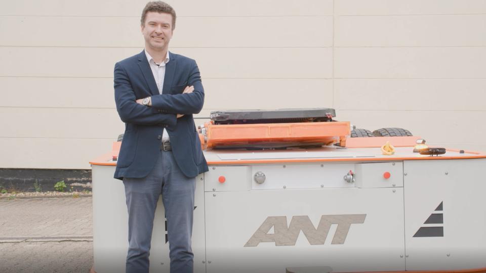 Vitaly Chukanov in front of his product, a semi-trailer with an electric engine