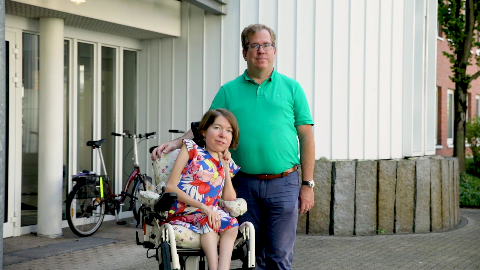 Holger and Petra Strack in front of a building