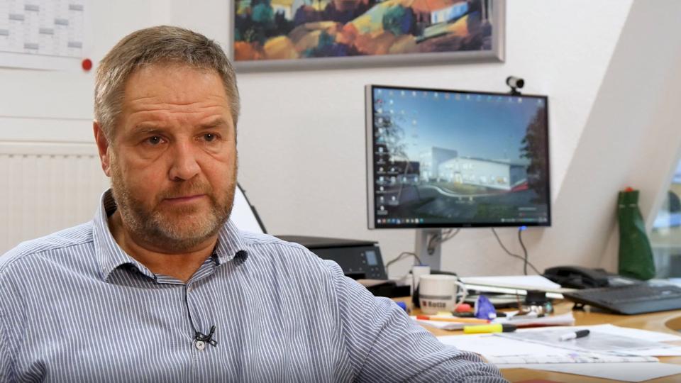 Ulrich Rotte in front of his desk