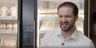 Alexander Eissing in front of refrigerator with food inside