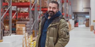 Canan Karadag, founder of the Karadag supermarkets, is standing in a storehouse