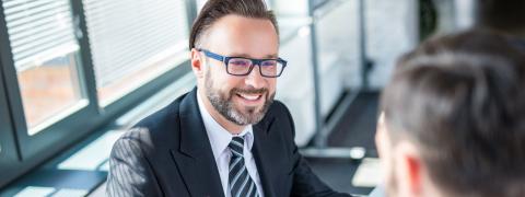 A consultant sitting opposite a man