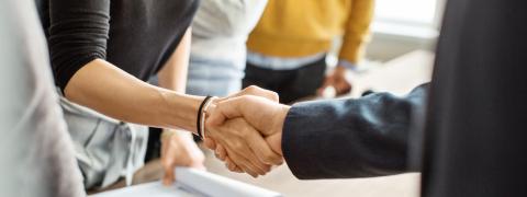 A handshake between a man and a woman