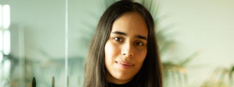 Mona Ghazi wearing black jeans and a black pullover