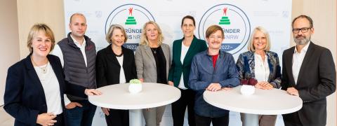 The jury members of the GRÜNDERPREIS stand at bar tables