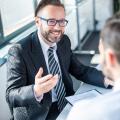 A consultant sitting opposite a man