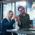 A younger man and an older woman fistbumping