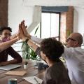 Four people giving each other a high five