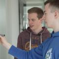 Nils Reichardt and Jonas Sander, two young men, standing at a whiteboard with a sketch.