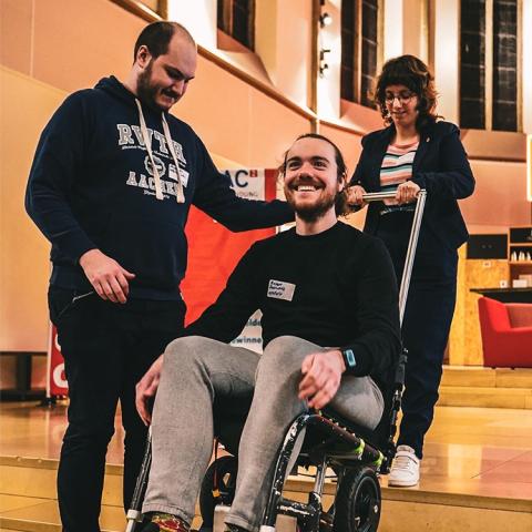 A man sitting on a special transportation chair