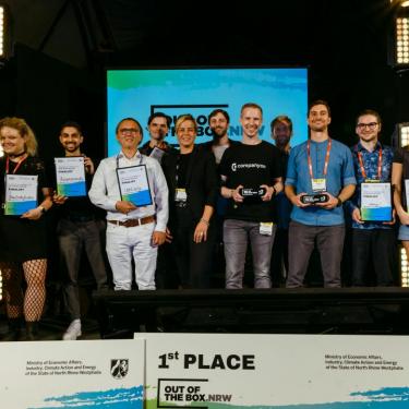 The three winner teams of the competition OUT OF THE BOX.NRW on the stage of the award show